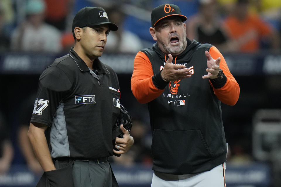 Baltimore Orioles manager Brandon Hyde, right, argues with home plate umpire Gabe Morales after Morales called Terrin Vavra out for running out of the baseline during the sixth inning of a baseball game against the Tampa Bay Rays Friday, Aug. 12, 2022, in St. Petersburg, Fla. (AP Photo/Chris O'Meara)