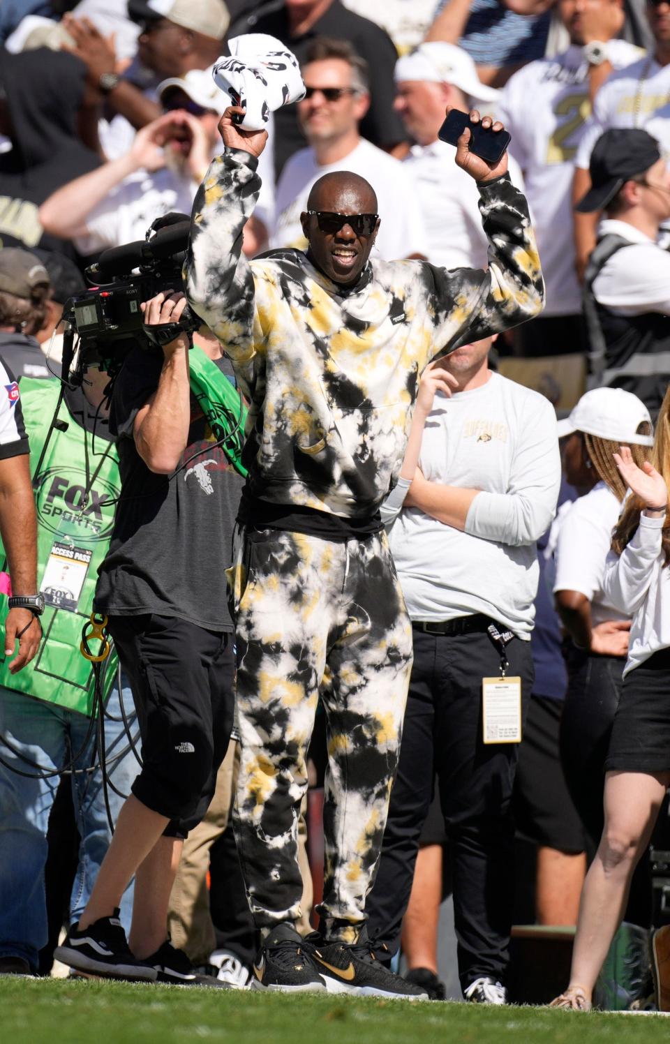 Retired NFL player Terrell Owens leads the crowd in a cheer in the second half of an NCAA college football game between Southern California and Colorado, Saturday, Sept. 30, 2023, in Boulder, Colorado.