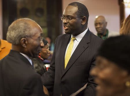 Rev. Clementa Pinckney (C), greets members of the congregation after the Watch Night service at Emanuel African Methodist Episcopal Church in Charleston, South Carolina in this December 31, 2012 file photo. REUTERS/Randall Hill/Files