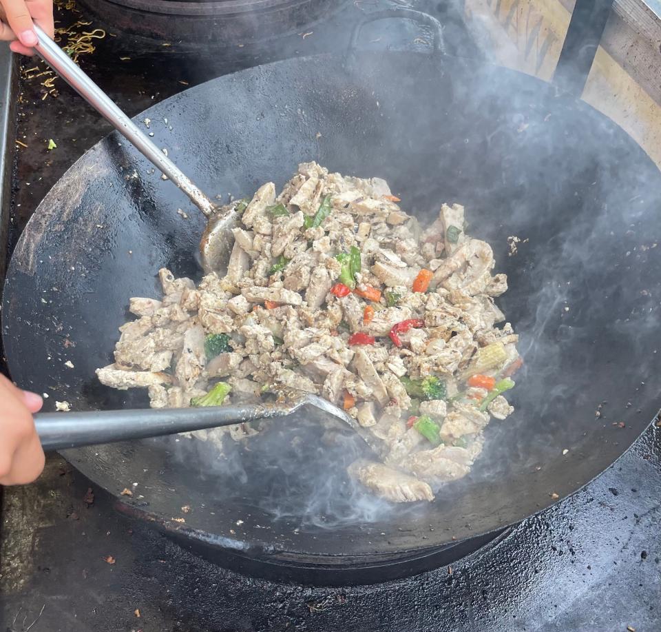 Island Noodles is a popular food choice among attendees of Musikfest. Pictured is the chicken being prepared in a wok.