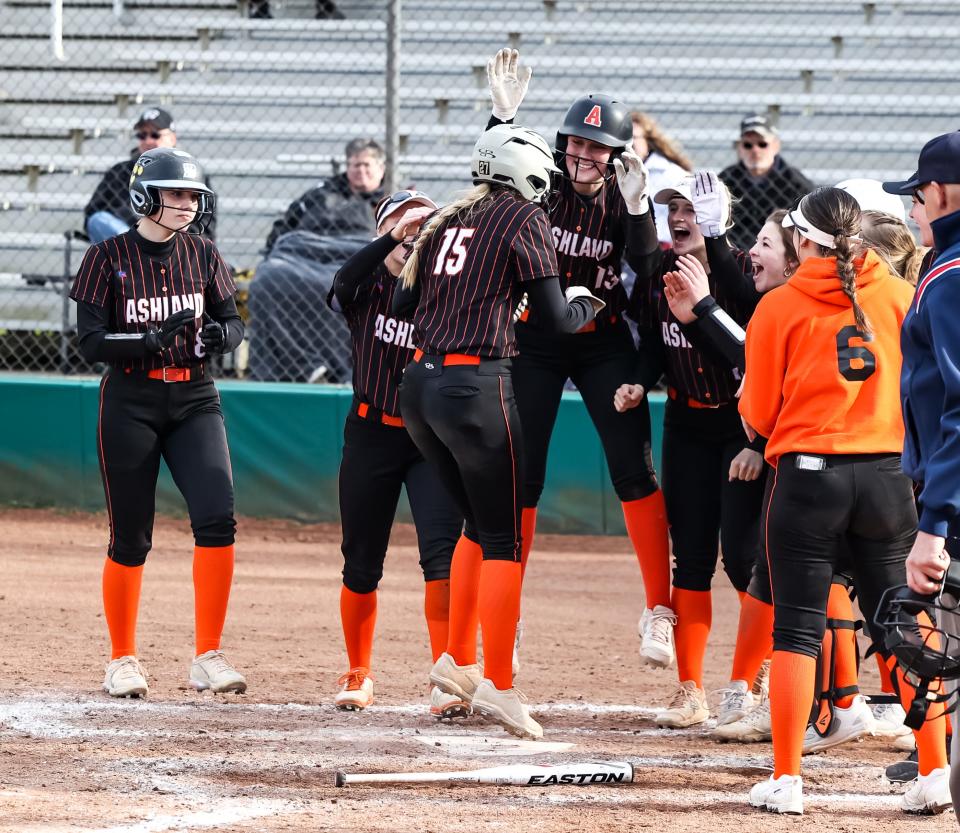 Madison Hoffman is mobbed at home plate by her teammates after her two-run shot in the sixth.