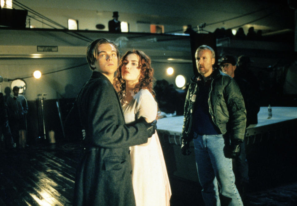 Cameron directs DiCaprio and Winslet during a scene for Titanic. 