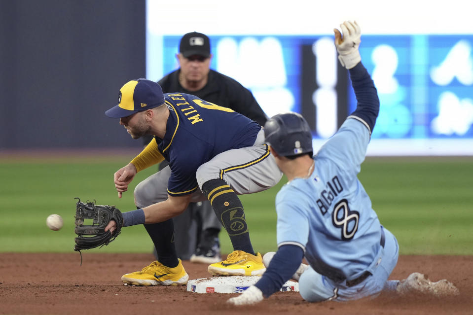 Milwaukee Brewers second baseman Owen Miller (6) forces out Toronto Blue Jays' Cavan Biggio (8) during the fifth inning of a baseball game Tuesday, May 30, 2023, in Toronto. (Nathan Denette/The Canadian Press via AP)