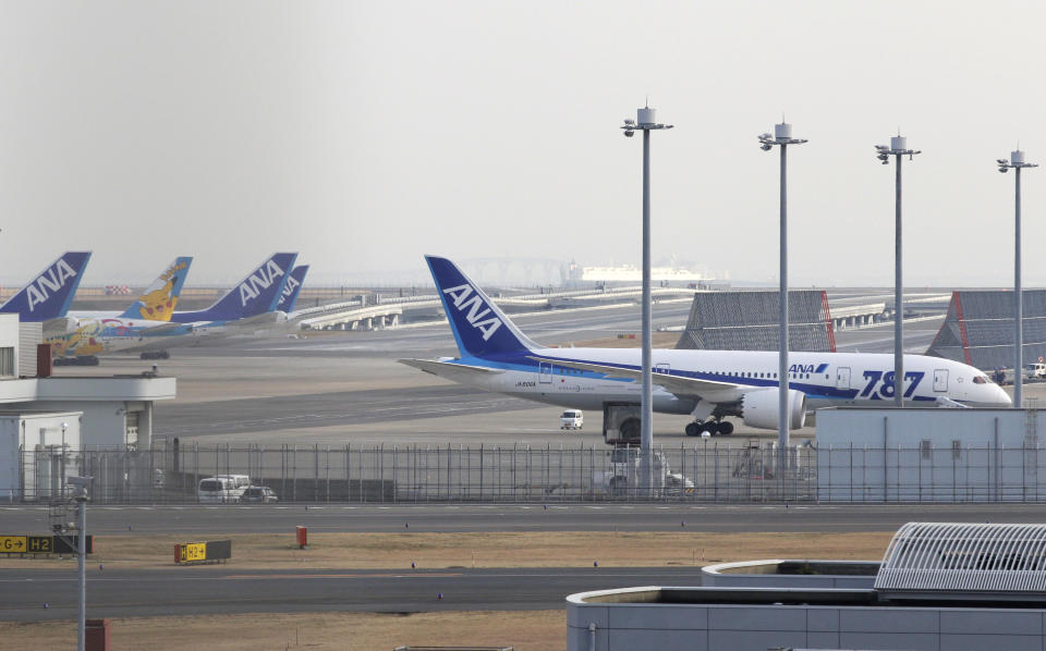 All Nippon Airways planes including a Boeing 787, right, are parked at Haneda Airport in Tokyo Wednesday afternoon, Jan. 16, 2013. ANA said a cockpit message showed battery problems and a burning smell were detected in the cockpit and the cabin, forcing another Boeing 787 on a domestic flight to land at Takamatsu airport in western Japan Wednesday morning. (AP Photo/Shizuo Kambayashi)