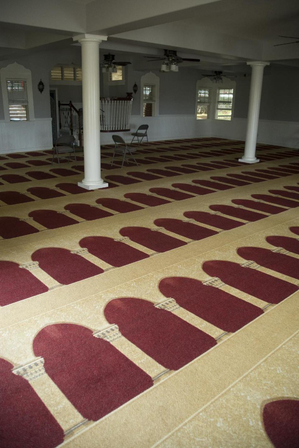 This Thursday, March 9, 2107 photo shows the prayer room of the Muslim Association of Hawaii building in Manoa Valley in Honolulu. The mosque has been serving Hawaii for nearly 50 years, according to the group. The column designs on the carpet are designed to face Mecca. (AP Photo/Marco Garcia)