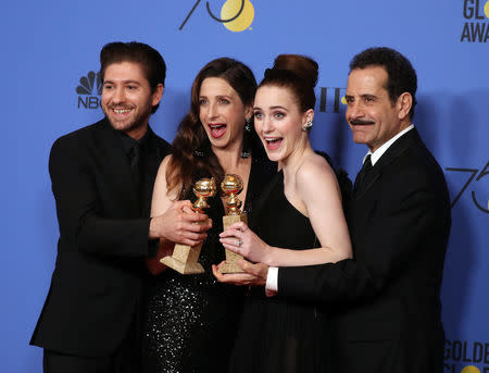 75th Golden Globe Awards – Photo Room – Beverly Hills, California, U.S., 07/01/2018 – Cast members (L-R) Michael Zegen, Marin Hinkle, Rachel Brosnahan, who holds her award for Best Performance by an Actress in a Television Series - Musical or Comedy, and Tony Shalhoub pose backstage after winning Best Televsision Series - Musical or Comedy for "The Marvelous Mrs. Maisel". REUTERS/Lucy Nicholson/Files