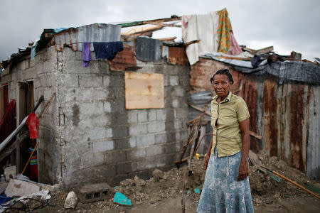 Rose Marie Michel, 64, poses for a photograph among the debris of her destroyed house after Hurricane Matthew hit Jeremie, Haiti, October 17, 2016. "My house was completely destroyed; no wall left standing, no traces of the roof or the things I had inside. I lost everything. I stayed with neighbours for a short time before moving to a shelter. I don't have anyone dead but right now I'm another Haitian homeless living in a shelter," said Michel. REUTERS/Carlos Garcia Rawlins