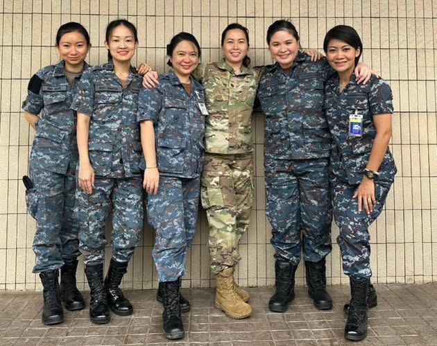 Air Force Major Jessica Padoemthontaweekij poses with five Thai students at the Air Command and Staff College. They are the first women ever admitted to the prestigious military school in Thailand.
