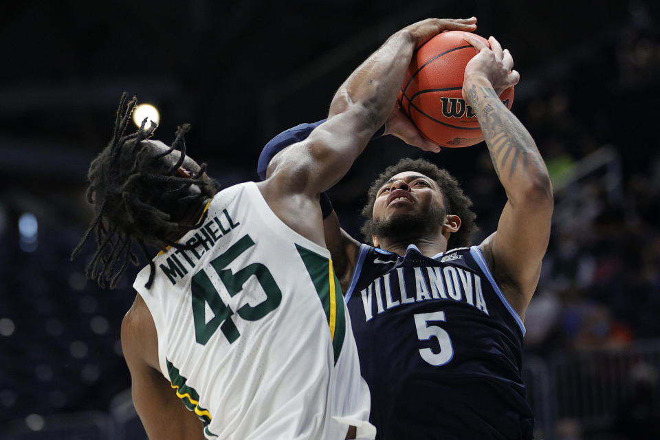 INDIANAPOLIS, INDIANA - MARCH 27: Davion Mitchell #45 of the Baylor Bears blocks a shot by Justin Moore #5 of the Villanova Wildcats in the second half of their Sweet Sixteen game of the 2021 NCAA Men's Basketball Tournament at Hinkle Fieldhouse on March 27, 2021 in Indianapolis, Indiana. (Photo by Sarah Stier/Getty Images)