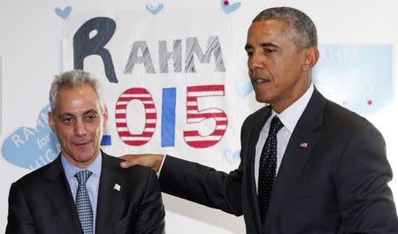 U.S. President Barack Obama puts his hand on Chicago Mayor Rahm Emanuel's shoulder as they visit a campaign office in Chicago February 19, 2015. REUTERS/Kevin Lamarque