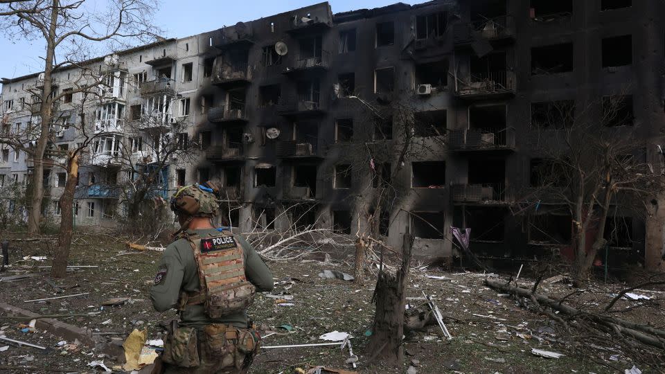 A Ukrainian police officer walks past a destroyed residential building, following artillery and air raids in the village of Ocheretyne, near the town of Avdiivka, in the Donetsk region, April 15, 2024. - Anatolii Stepanov/AFP/Getty Images