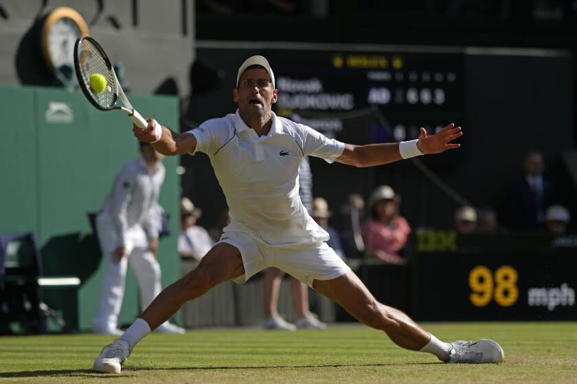 Serbia's Novak Djokovic returns to Britain's Cameron Norrie in a men's singles semifinal