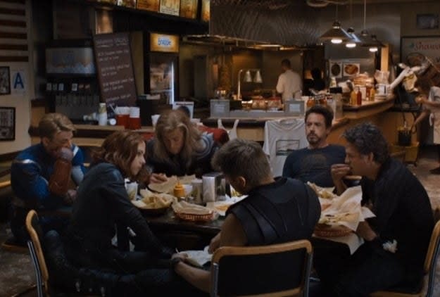 "The Avengers" characters sit and eat at a shawarma restaurant