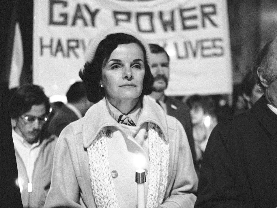 FILE - San Francisco Mayor Dianne Feinstein carries a candle as she leads an estimated 15,000 marchers also carrying candles during a march in memory of slain Mayor George Moscone and Supervisor Harvey Milk in San Francisco, Nov. 28, 1979. In the background is a sign that says "Gay Love is Gay Power." (AP Photo/Paul Sakuma, File)