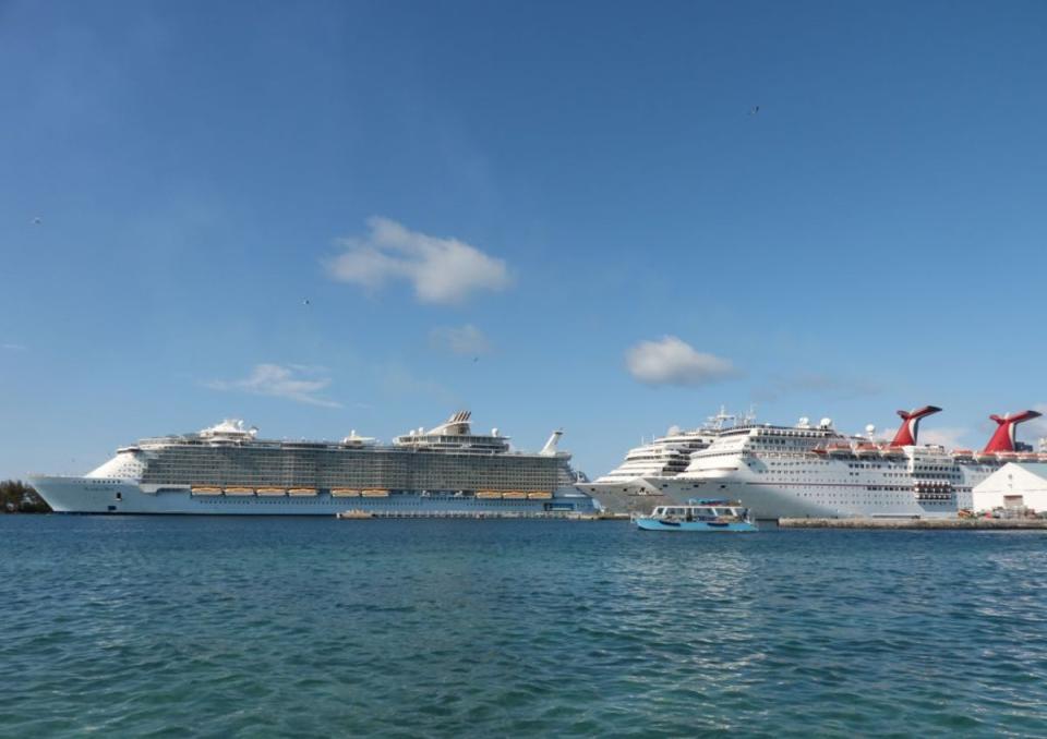 The Carnival Elation cruise ship is pictured (right) in a file photo (AFP via Getty Images)