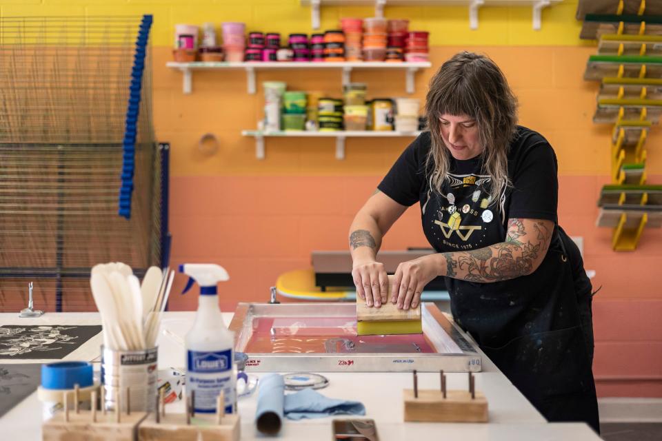 Amanda Burk, owner of Flat File Print Shop, works on a print at her studio on Friday, July 29, 2022 in Athens. Burk has been in the printmaking business for 20 years and opened Flat File Print Shop this past June.