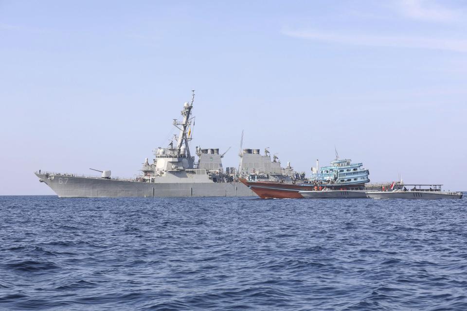 In this photo released by the U.S. Navy, the guided-missile destroyer USS Cole is seen as its sailors transfer control of a stateless fishing vessel to the Yemen Coast Guard in the Gulf of Oman, Jan. 21, 2022. The wars of the wider Middle East that long surrounded the United Arab Emirates now have encroached into daily life in this U.S.-allied nation, threatening to draw America further into a region inflamed by tensions with Iran. The Cole is due to travel to the United Arab Emirates as part of an American response to the attacks. (U.S. Navy via AP)