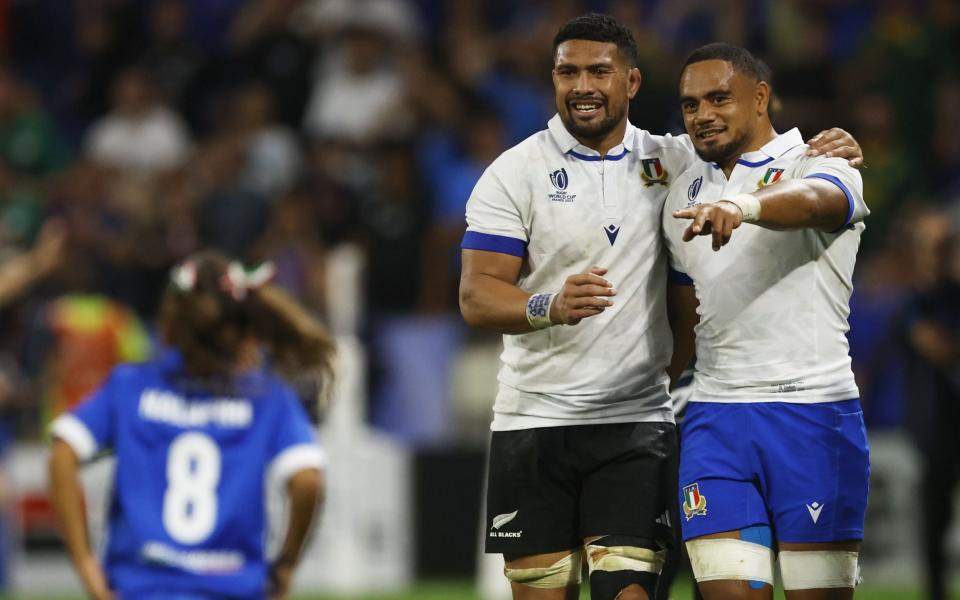 New Zealand's Ardie Savea (L) and Italy's Toa Halafihi share a smile