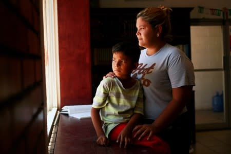 Honduran migrant Denia Carranza and her son Robert, who have given up their U.S. asylum claim under the Migrant Protection Protocol (MPP), pose for a photo at Casa del Migrante migrant shelter, in Ciudad Juarez