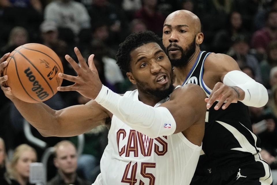 Cleveland Cavaliers' Donovan Mitchell drives past Milwaukee Bucks' Jevon Carter during the first half of an NBA basketball game Friday, Nov. 25, 2022, in Milwaukee. (AP Photo/Morry Gash)