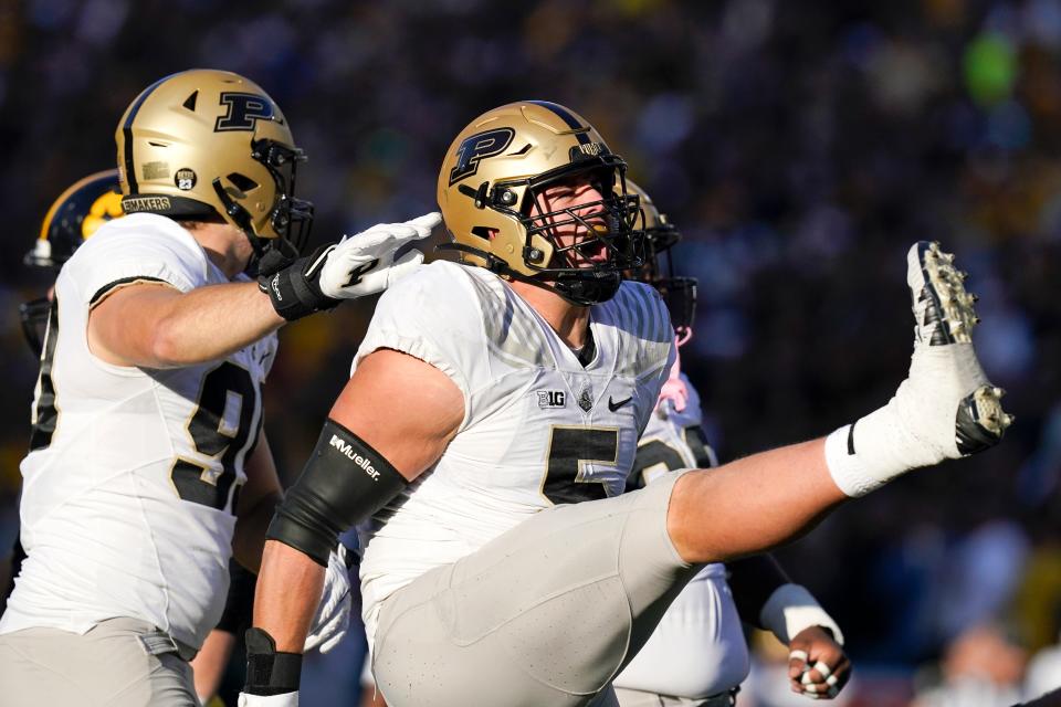 Purdue defensive end George Karlaftis (5) celebrates after a sack during the second half of an NCAA college football game against Iowa, Saturday, Oct. 16, 2021, in Iowa City, Iowa. Purdue won 24-7. (AP Photo/Charlie Neibergall)