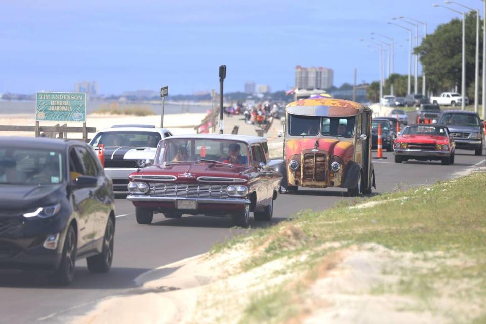 Antique and classic cars Cruisin’ The Coast mix with daily traffic along the beach on U.S. 90.