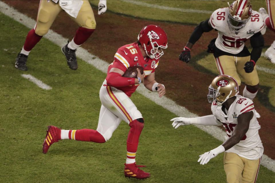 Kansas City Chiefs quarterback Patrick Mahomes (15) runs for a touchdown, the first score of Super Bowl LIV. (AP Photo/Charlie Riedel)