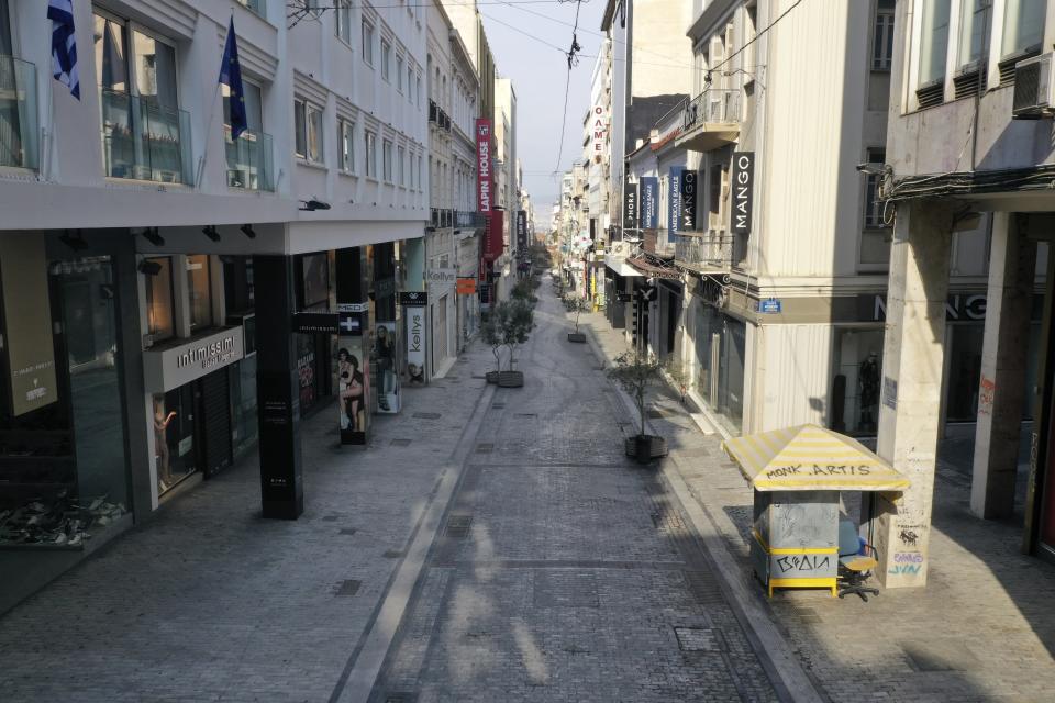 In this Wednesday, April 1, 2020 photo, a view of a deserted Ermou street, Athens' main shopping area. Deserted squares, padlocked parks, empty avenues where cars were once jammed bumper-to-bumper in heavy traffic. The Greek capital, like so many cities across the world, has seen its streets empty as part of a lockdown designed to stem the spread of the new coronavirus. (AP Photo/Thanassis Stavrakis)