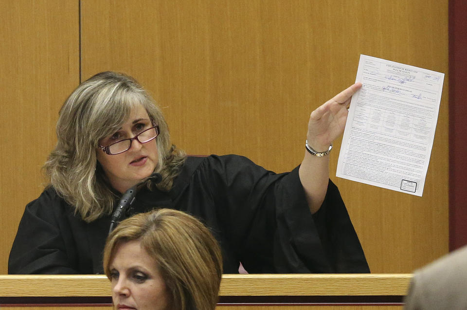 FILE - Mobile County Circuit Judge Sarah Stewart holds up a document in her courtroom, April 16, 2015, as she sentences William Ziegler in Mobile, Ala. Alabama Republicans are deciding their choice to replace retiring Chief Justice Tom Parker who in February 2024 drew national attention for quoting the Bible in a legal writing supporting a decision to recognize frozen embryos as children under a state law. Stewart, a current associate justice on the Alabama Supreme Court and Bryan Taylor, a former state senator and legal adviser to two governors, are competing for the GOP nomination. (Sharon Steinmann/AL.com via AP)