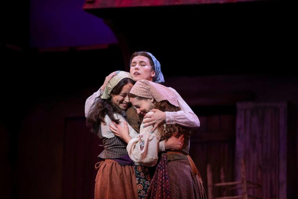 Lexington Theatre Company performers in “Fiddler on the Roof” embrace after the end of a scene on Monday, July 8, 2024, at Lexington Opera house in Lexington, Kentucky.