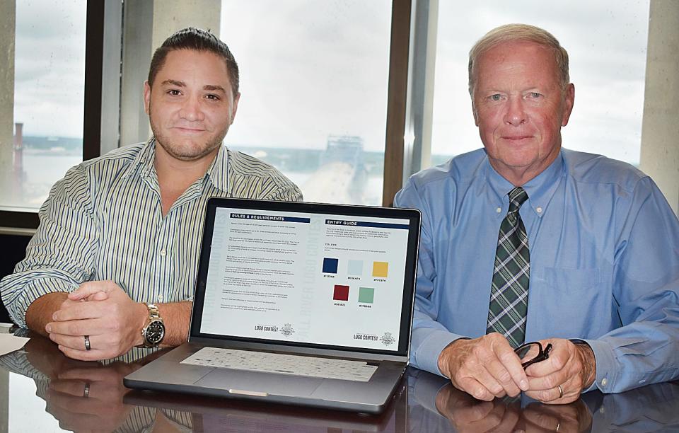 Josh Pereira of Solmos Creative and Mayor Paul Coogan work on rebranding for the city.