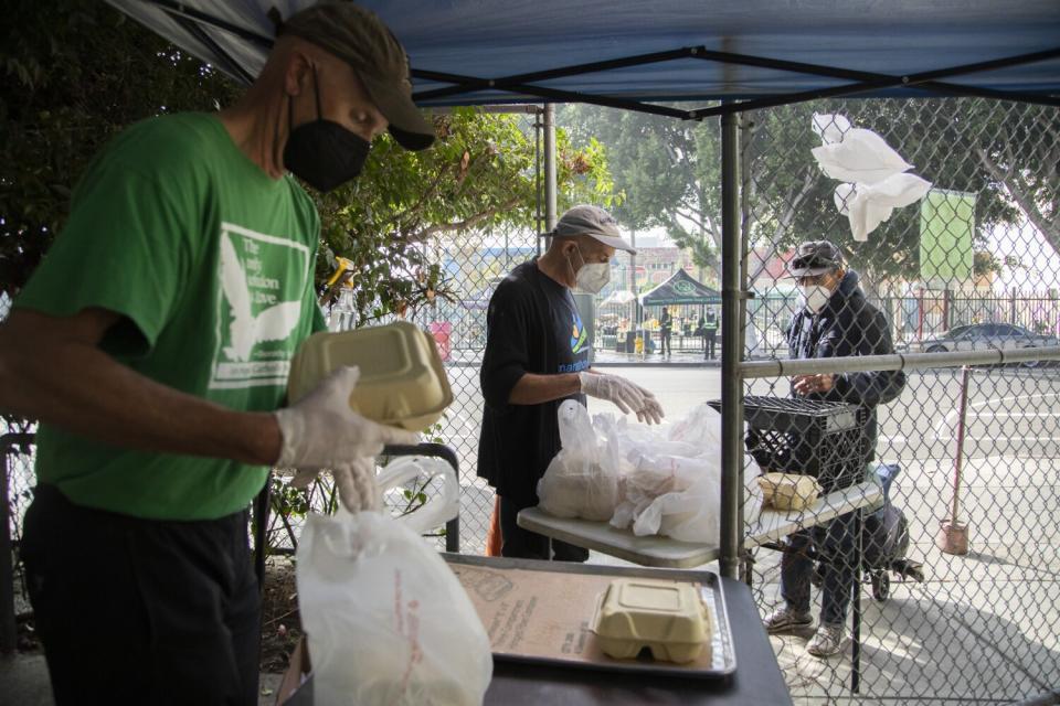 Volunteers hand out lunch on skid row.