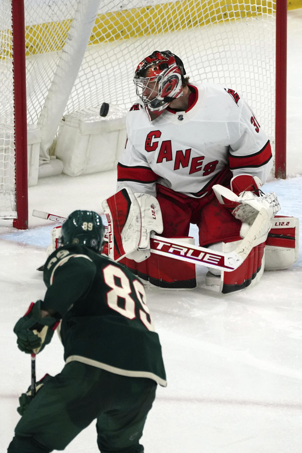 Minnesota Wild's Frederick Gaudreau (89) scores a goal against Carolina Hurricanes goalie Frederik Andersen (31) in the third period of an NHL hockey game, Saturday, Feb. 12, 2022, in St. Paul, Minn. (AP Photo/Jim Mone)