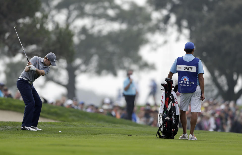 Jordan Spieth, left, hits his second shot on the second hole of the South Course at Torrey Pines during the final round of the Farmers Insurance Open golf tournament Sunday, Jan. 26, 2014, in San Diego. (AP Photo/Gregory Bull)