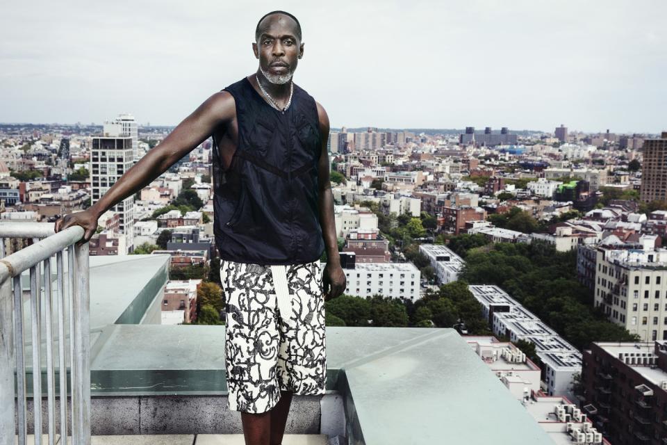 Michael K. Williams photographed on the roof of his apartment building, with Brooklyn unfurled behind him.