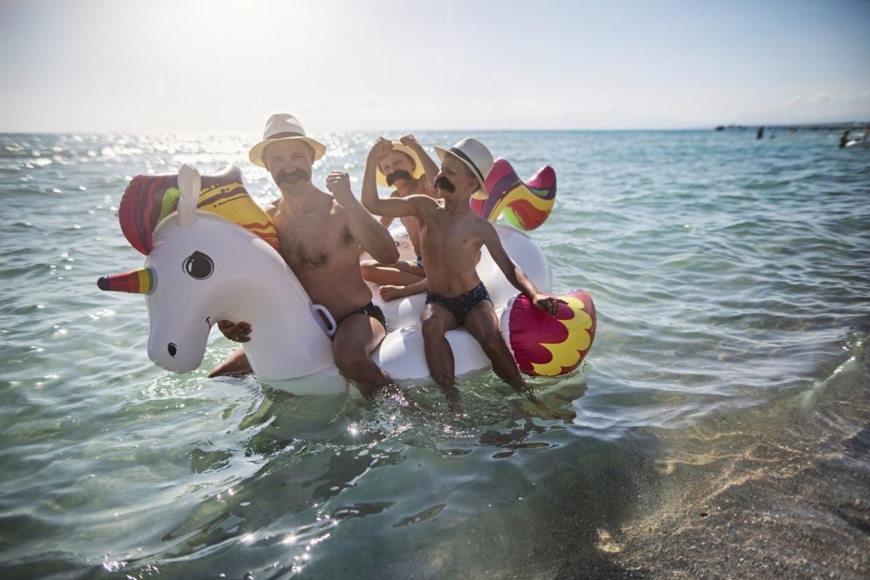 funny father ands sons all wearing giant moustaches playing at sea nikon d850