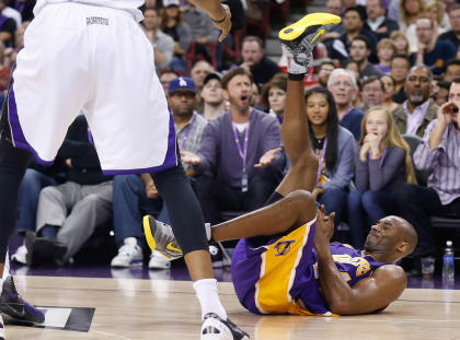 Kobe Bryant goes to the ground during the second quarter of the Lakers' loss to the Kings on Sunday. (USAT)