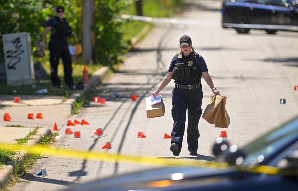 Police and crime scene investigators were on the scene collecting evidence where three people died and six were injured following a shooting early Sunday near 57th Street and Prospect Avenue in Kansas City. Tammy Ljungblad/tljungblad@kcstar.com
