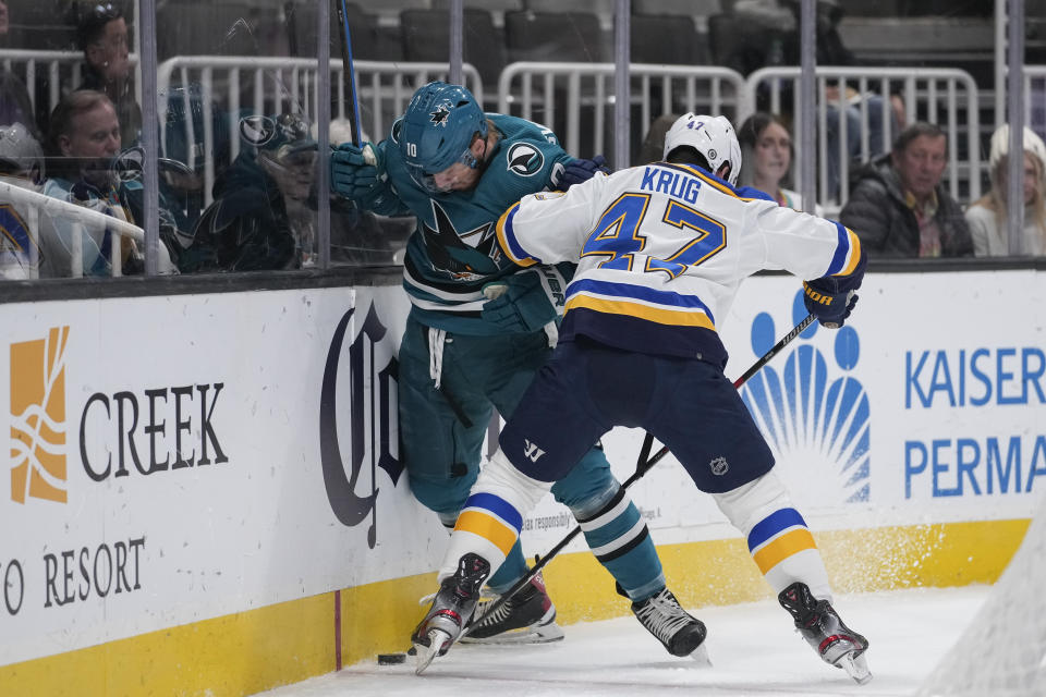 San Jose Sharks left wing Evgeny Svechnikov, left, and St. Louis Blues defenseman Torey Krug compete for possession of the puck during the first period of an NHL hockey game in San Jose, Calif., Thursday, March 2, 2023. (AP Photo/Godofredo A. Vásquez)