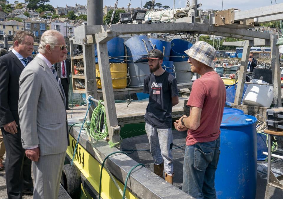 The Prince of Wales talks to local fishermen (Arthur Edwards/The Sun/PA) (PA Wire)