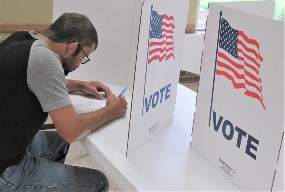 David Zook completes his ballot during the primary election on Tuesday at Holmes Fire District No. 1.