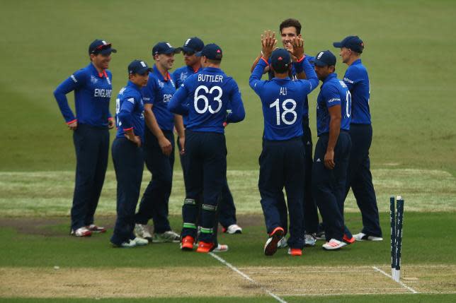 Steven Finn of England celebrates with his team mates after taking the wicket of Marlon Samuels.