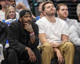 Dallas Mavericks' Kyrie Irving, left, and Luka Doncic, right, watch from the bench during the second half of an NBA basketball game against the Detroit Pistons, Friday, April 12, 2024, in Dallas. Doncic and Irving were not playing due to injuries. (AP Photo/Jeffrey McWhorter)