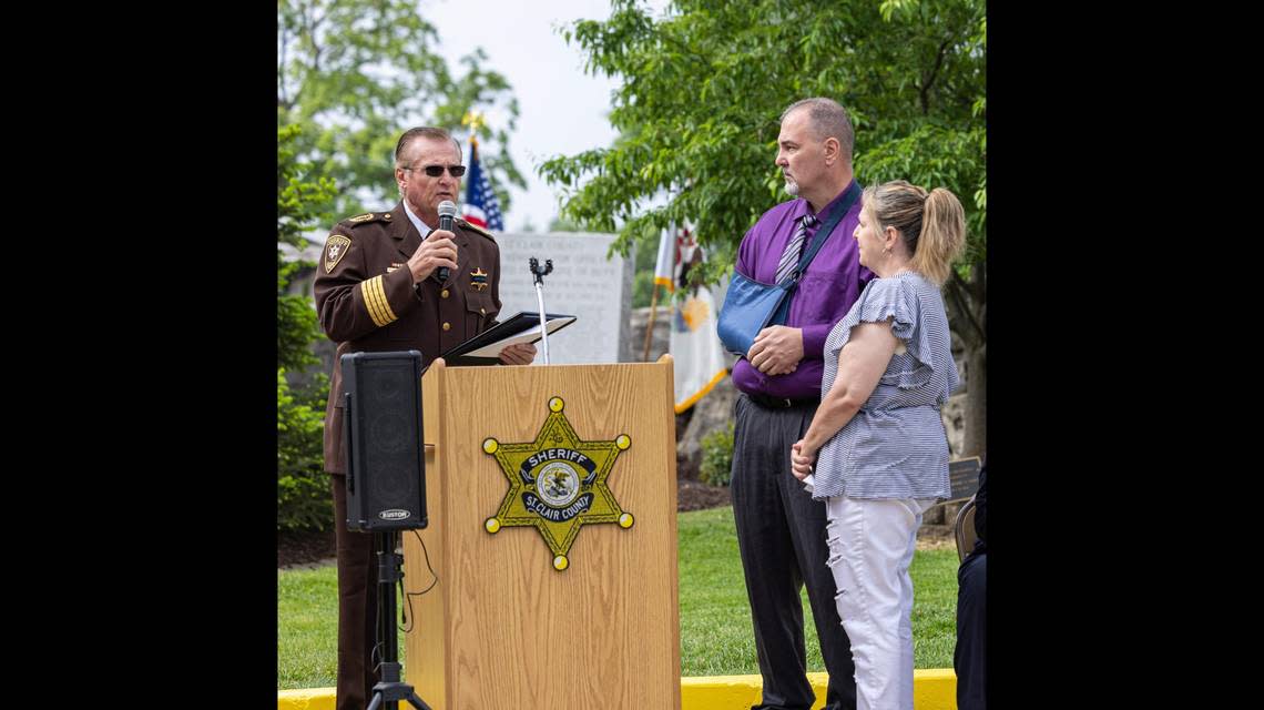 St. Clair County Sheriff Richard Watson Tuesday presents the citation of valor award to Dupo Police Sgt. Patrick Carrier, who was shot in the line of duty in February.