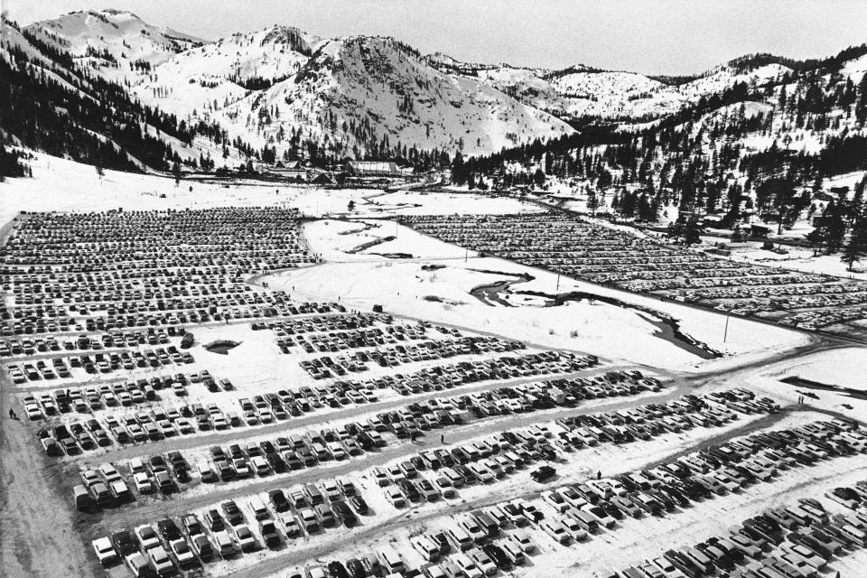 FILE - In this February 1960 file photo, a parking pad of compacted snow is jammed with thousands of automobiles at Squaw Valley during the Winter Olympics in Olympic Valley, Calig. California's Squaw Valley Ski Resort is considering changing its name to remove "squaw," a derogatory term for Native American women. Squaw Valley President & CEO Ron Cohen says resort officials are meeting with shareholders and the local Washoe tribal leadership to get their input. He says he can't give a timeline on when the decision will be made. The renaming of Squaw Valley Ski Resort is one of many efforts across the nation to address colonialism and indigenous oppression. (AP Photo, File)