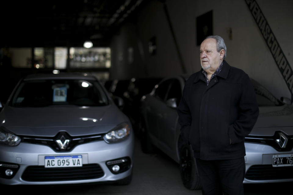 Carlos Avoguarda stands outside his auto shop in Buenos Aires, Argentina, Tuesday, Aug. 13, 2019. Two days after the overwhelming primary election loss of President Mauricio Macri sent the Argentine peso into a tailspin, not a single customer has walked through the door. (AP Photo/Natacha Pisarenko)