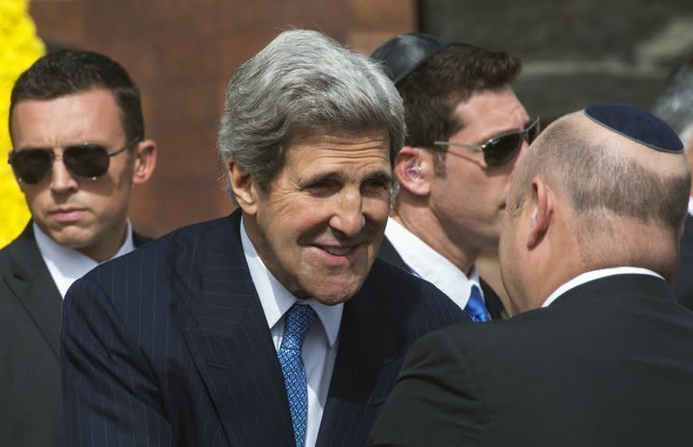 US Secretary of State John Kerry (C) greets officials shortly before placing a wreath from the United States at the Yad Vashem memorial in Jerusalem during Holocaust Memorial Day on April 8, 2013. Kerry on Monday said he was pursuing a "quiet strategy" for breaking the years-long impasse in Israeli-Palestinian peace talks, warning the process could not be rushed