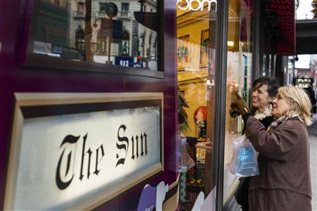 Pedestrians stop to look at holiday window displays at Macy's flagship store in New York, November 22, 2013. REUTERS/Lucas Jackson