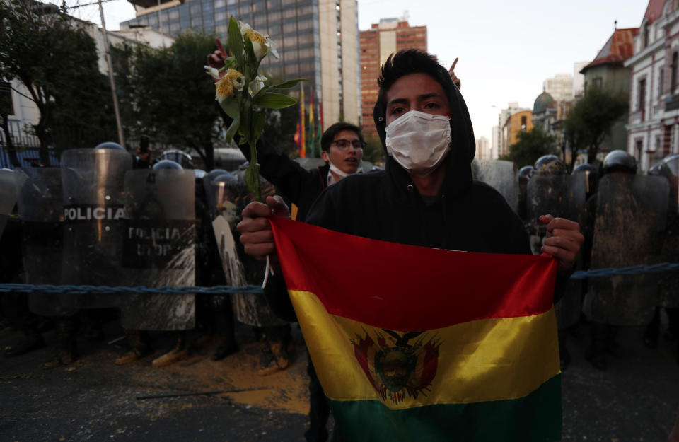 A youth attends an anti-government march in La Paz, Bolivia, Tuesday, Oct. 22, 2019. International election monitors expressed concern over Bolivia's presidential election process Tuesday after an oddly delayed official quick count showed President Evo Morales near an outright first-round victory — even as a more formal tally tended to show him heading for a risky runoff. (AP Photo/Juan Karita)