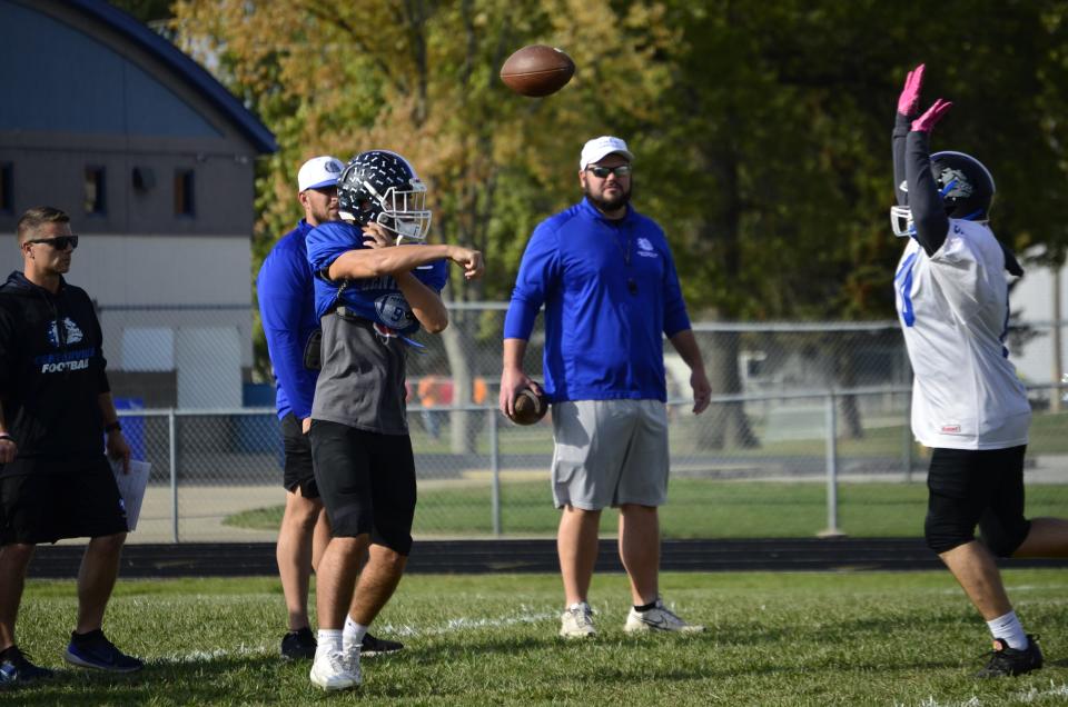 Centerville senior quarterback Jake Tinkle throws a pass in practice ahead of the Bulldogs' first round sectional game against Lawrenceburg, Wednesday, Oct. 18, 2023.